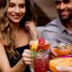 woman and man cheers drinks
